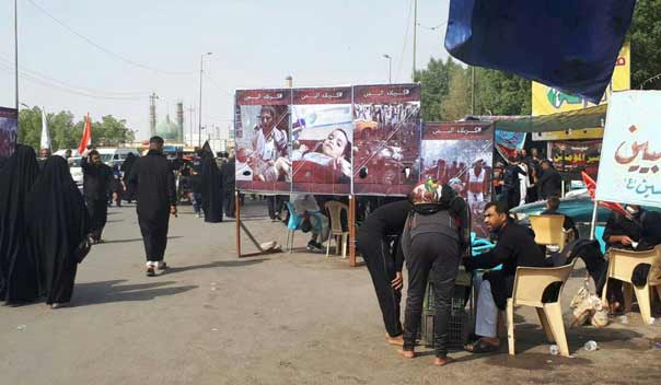 بالصور..ناشطون يمنيون يقيمون عدة معارض صور في العراق لفضح جرائم العدوان السعودي بالتزامن مع اربعينة الأمام الحسين(ع)